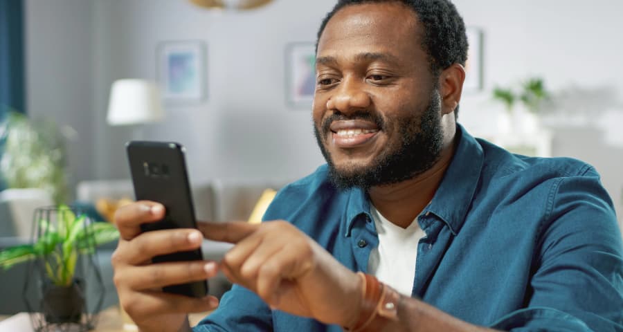 Man sitting down using an app on his cell phone